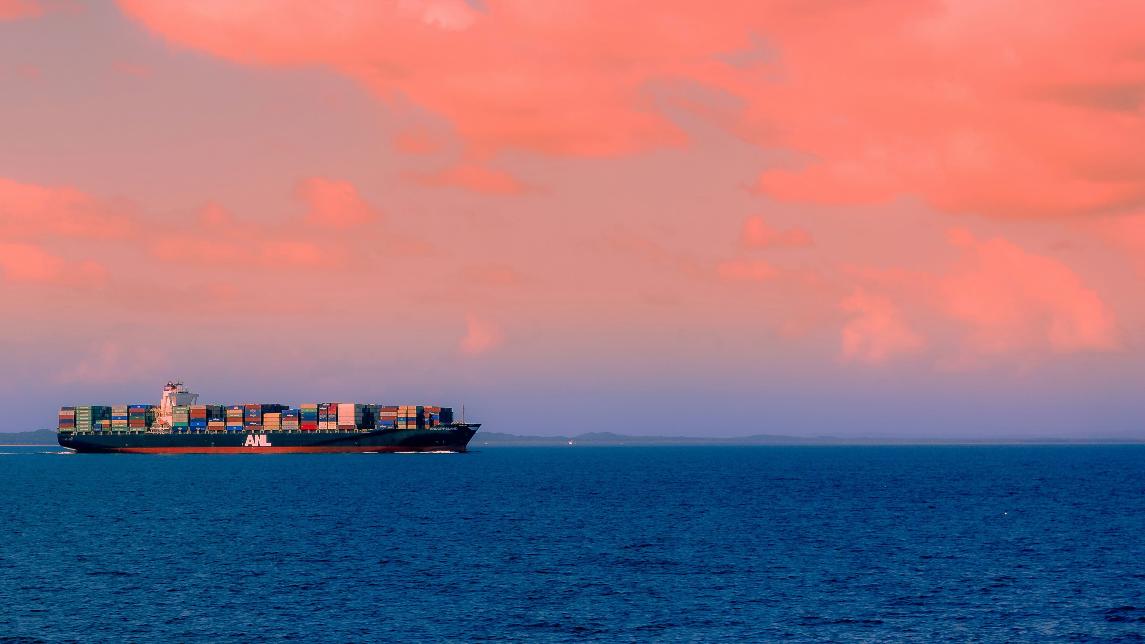 Large container ship in a modern port representing the IMEC corridor and global trade shift.